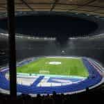 Estadio de fútbol con pista de atletismo.