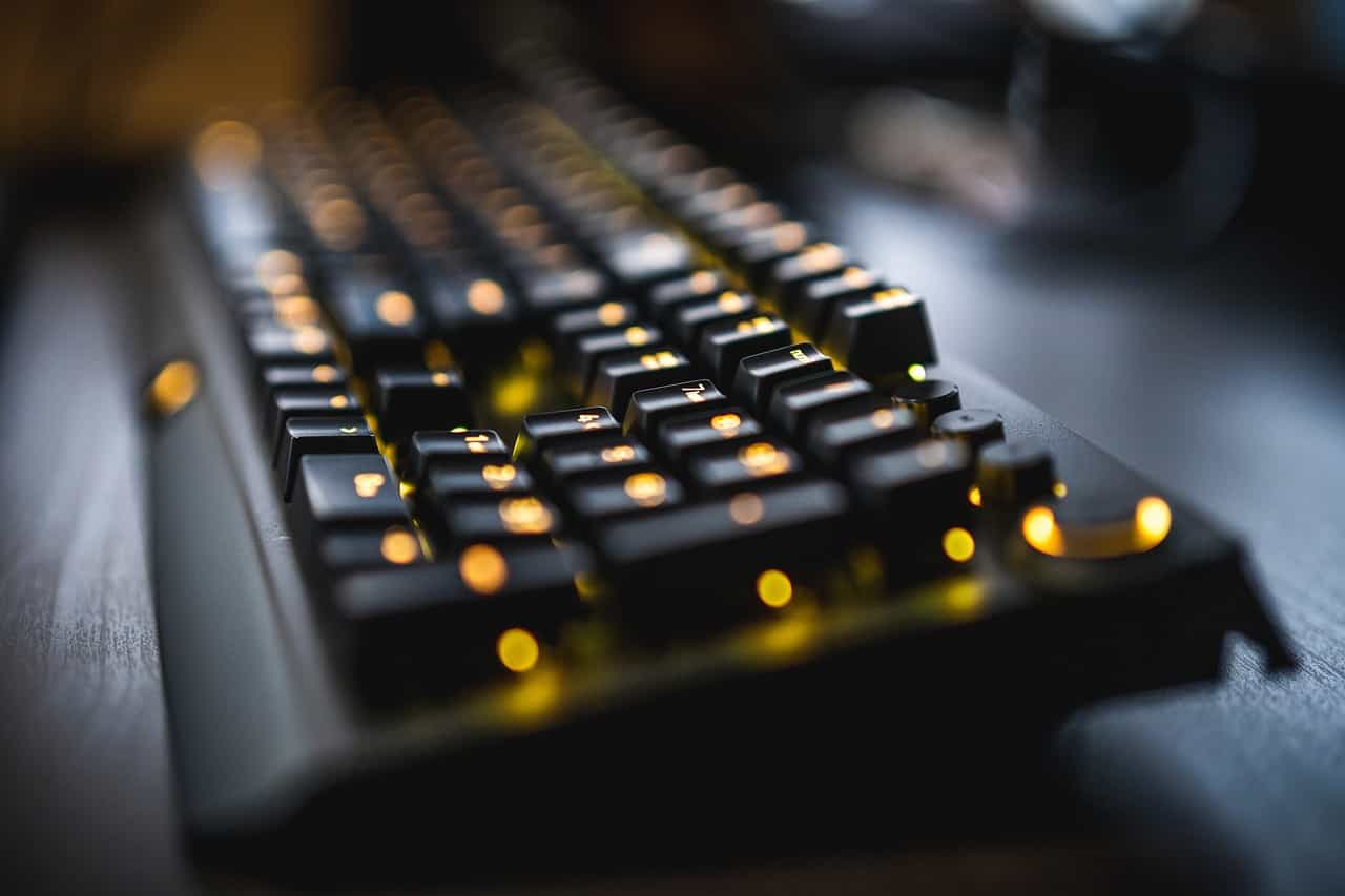 Teclado de ordenador iluminado por lucecitas amarillas.